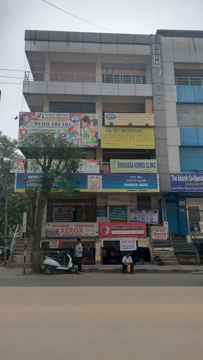 Published Suchitra building photograph showing Pinnacle signage above Mahesh Bank.